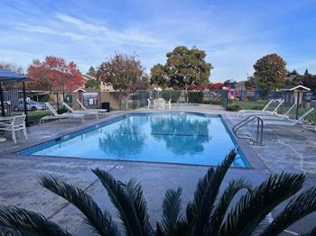 a swimming pool with chairs around it